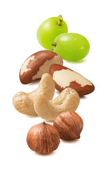 Cashew, hazelnut, brazil nuts and green grapes isolated on white background. Nut mix. Vertical layout.