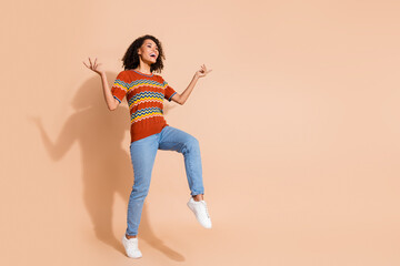 Fototapeta na wymiar Full body photo of positive cute girl dressed ornament t-shirt jeans look at discount empty space isolated on pastel color background