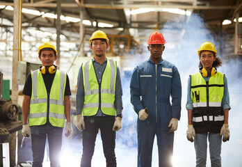 portrait group of engineers or workers standing and walking in the factory