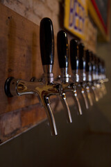  Drinks. Classic metal craft beer taps in the bar.