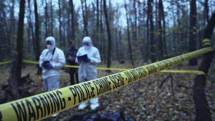 Investigator and forensic experts work at a crime scene, dedicated to evidence collection 