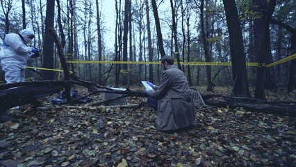 Detective examines evidence in a plastic bag from a crime scene in the forest, drawing conclusions 