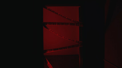 Police emergency lights flash at a crime scene, the door closed with warning tape 