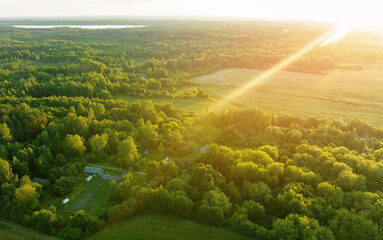 Rural landscape, aerial view. Country houses in countryside. Village Home in Country on sunset....
