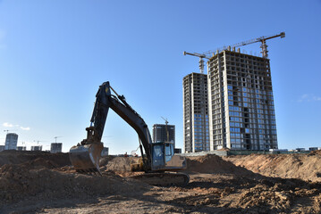 Construction site. Excavator on groundwork. Backhoe dig foundation for house construction. Building...