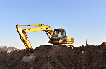 Excavator on earthmoving. Open-pit mining. Backhoe dig ground in quarry. Heavy construction...
