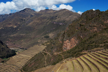 terraces and mountains in the Sacred Valley of the Incas in Pisac on a blue sky sunny day with clouds - obrazy, fototapety, plakaty