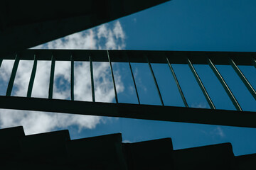 bottom view of the staircase and blue sky - obrazy, fototapety, plakaty