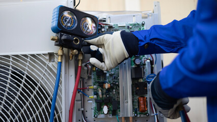 Close up Air conditioner's technician hand check  fill refrigerant liquid and maintenance condensor...