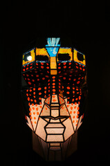 Colorful glowing face mask on a black background