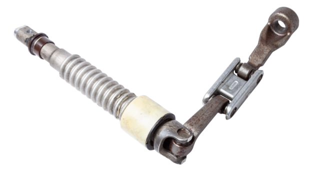 The spare part of the car is a metal steering propeller shaft with hinges on a white background with inscriptions designating the model. Repair of equipment at the auto-parsing in the workshop.