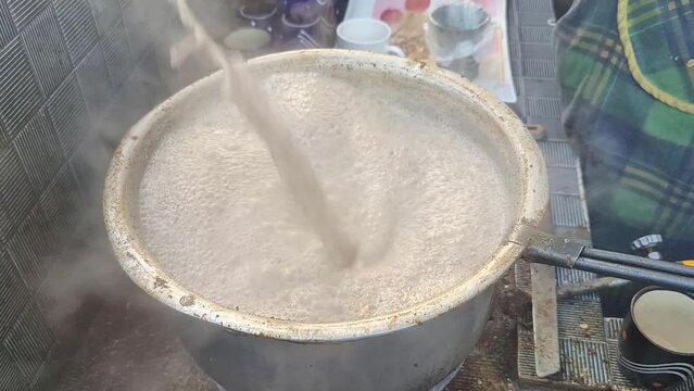 Making Hot Tea or chai video. Pakistani tea made with cows milk , sugar and cardamom pod. Cardamom chai latte. Tea made in a pot on a stove. 