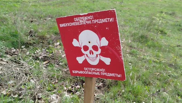 the sign Beware of Mines is installed on the minefield