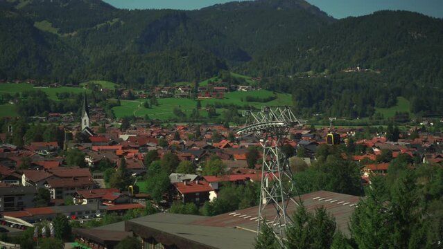 Nebelhornbahn. Allgau, Oberstdorf, Germany. Cable car to the high mountain in Bavaria in city of Oberstdorf. Gondola cabins move on sunny day in Bavarian alps. Bergbahn am Nebelhorn. 