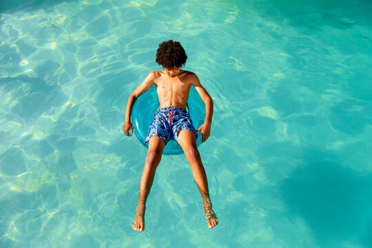 Teenage Boy Outgrows The Kid Sized Pool Floatie 