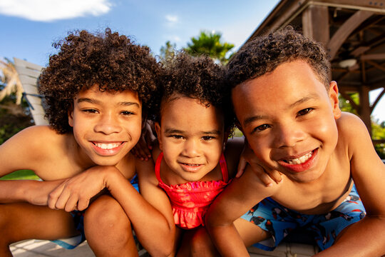 Wide Angle Image Of Kids Smiling At Camera During Summer