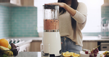 Blender, smoothie and woman in kitchen for diet, detox and healthy morning breakfast in home. Fruit, food and hand of female person with machine for nutrition drink, vitamins or weight loss milkshake