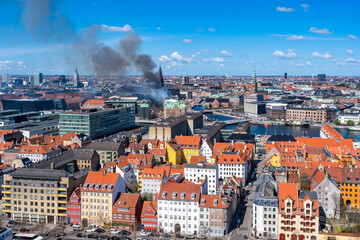 Black smoke drifts over central Copenhagen as historic Copenhagen Stock Exchange goes up in flames. Denmark