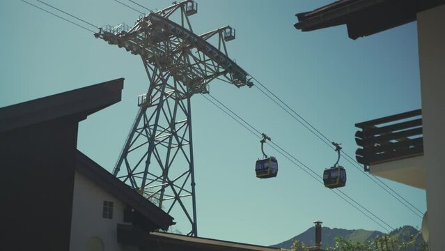 Nebelhornbahn. Allgau, Oberstdorf, Germany. Cable car to the high mountain in Bavaria in city of Oberstdorf. Gondola cabins move on sunny day in Bavarian alps. Bergbahn am Nebelhorn. 