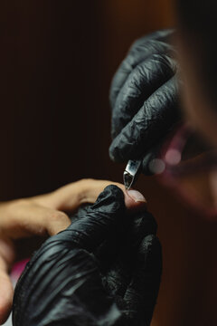 Removing the nail cuticula.
