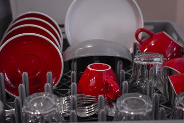 Close-up of washed cups and plates drying in the kitchen. Close-up of clean dishes. Dishwasher. High quality photo