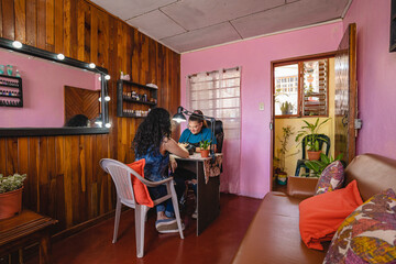 Manicurist working in her salon. 
