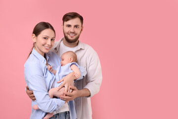 Happy family. Parents with their cute baby on pink background, space for text