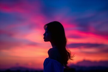 Silhouette of a Young Woman at Sunset