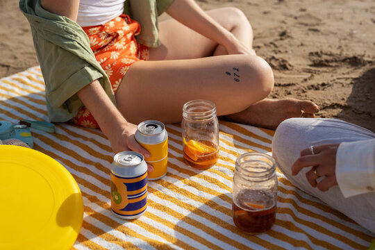 Anonymous girls picnicking at beach