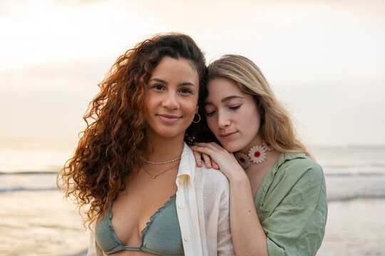 Portrait of two beautiful women in front of the sea