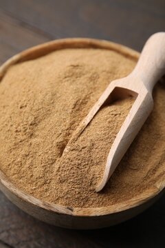 Dietary fiber. Psyllium husk powder in bowl and scoop on table, closeup