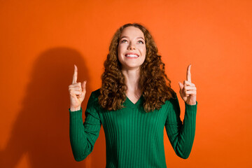 Photo of funky dreamy lady dressed green shirt looking showing two fingers up emtpy space isolated orange color background