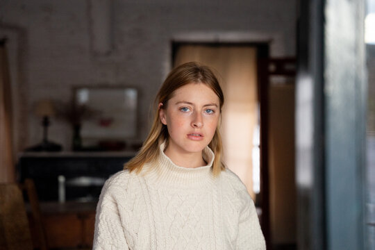 Woman Wearing Sweater In Mediterranean Interior