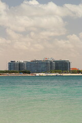 A large building with a beach in the background