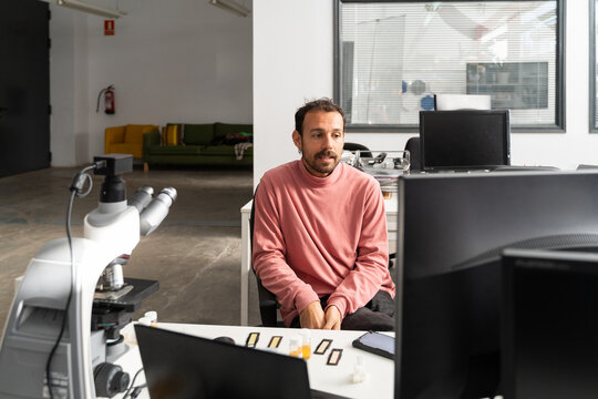  scientist researcher working on biotech laboratory office