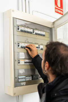 man turn off electrical panel
