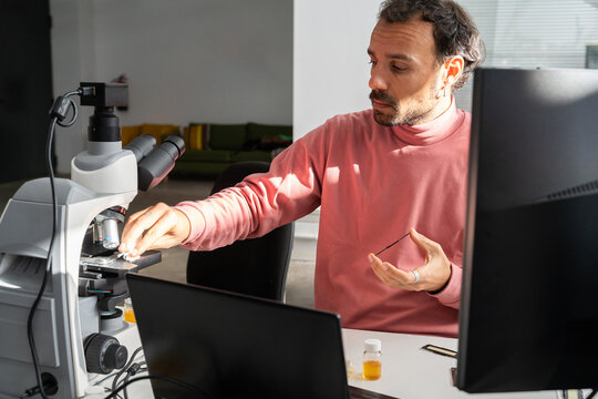  scientist researcher working on biotech laboratory office