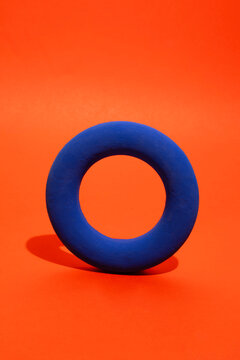 Still life image of colourful geometric ring with strong shadows