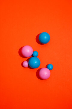 Still life image of colourful geometric balls with strong shadows