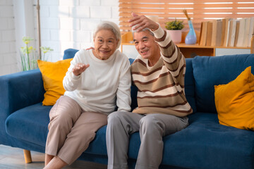 Elderly Romance in the 60s and 70s: Grandparents Sharing Laughter and Hugs on the Couch, Embracing the Joys of Retirement Together, A Heartwarming Indoor Scene of Mature Love and Relaxation