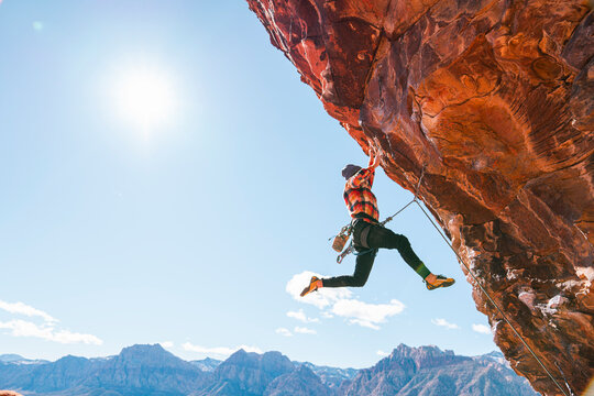 Man lead climbing outside