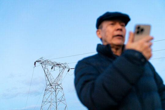 Powerline with Elderly Asian Man Talking On Cellphone