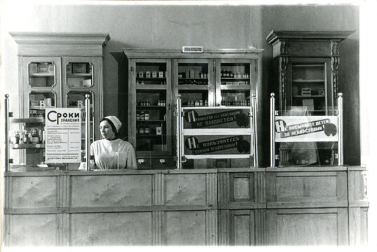 Female Pharmacist Standing at Checkout Counter 