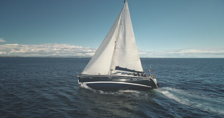 Slow motion closeup of sail luxury yacht at ocean bay aerial. Boat race at open sea. Sailboat...