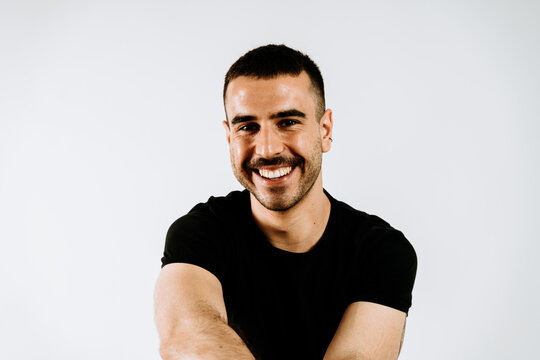 Portrait of a man smiling on a white background.
