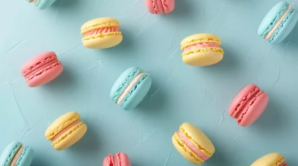 Plexiglas foto achterwand Colorful cake macaron or macaroon on turquoise pastel background from above. French almond cookies or dessert, top view. Seamless pattern tile. © JovialFox
