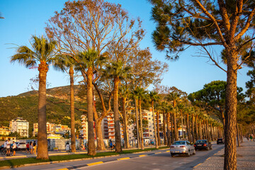 Vlora, Albania, July 2023. Resort town with hotels, palm trees and cars on the highway