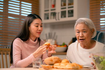 Family Togetherness in the Kitchen: Asian Mother Prepares a Happy Dinner, Joined by Father, Daughter, and Senior Elderly, Creating Fun and Memorable Meals, A Heartwarming Holiday Gathering