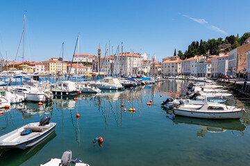 Colorful boats in serene harbor of coastal town Piran, Slovenia, Europe. Tranquil Venetian port in...