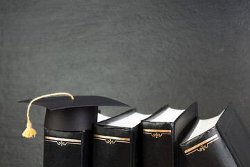 education concept. Graduation hat with gold tassel on the books. Law concep- with copy space for your ad text. - obrazy, fototapety, plakaty